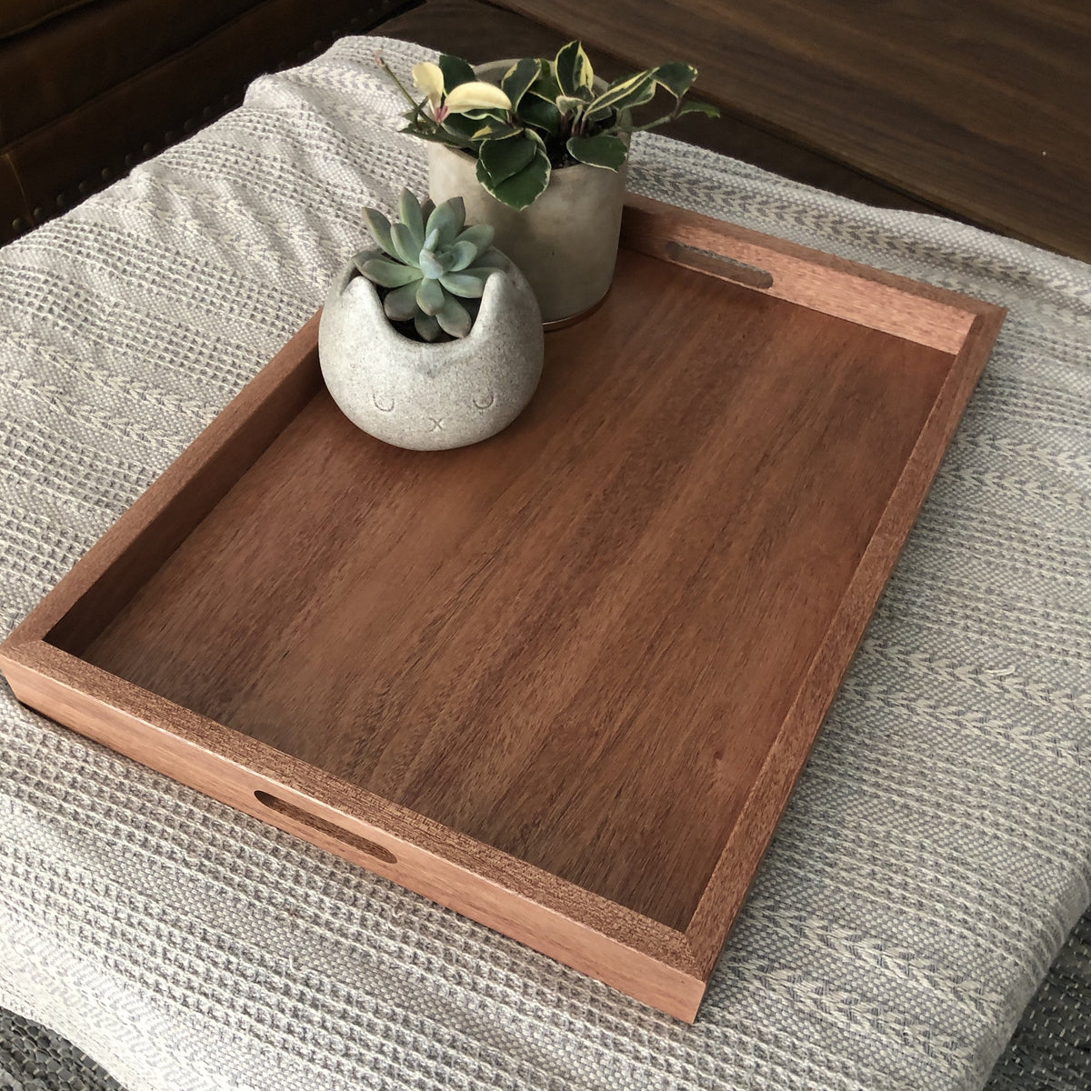 Wooden tray store on ottoman