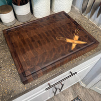 Wooden cutting board with knife design on a kitchen counter