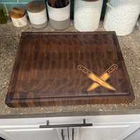 Wooden cutting board with knife design on a kitchen counter