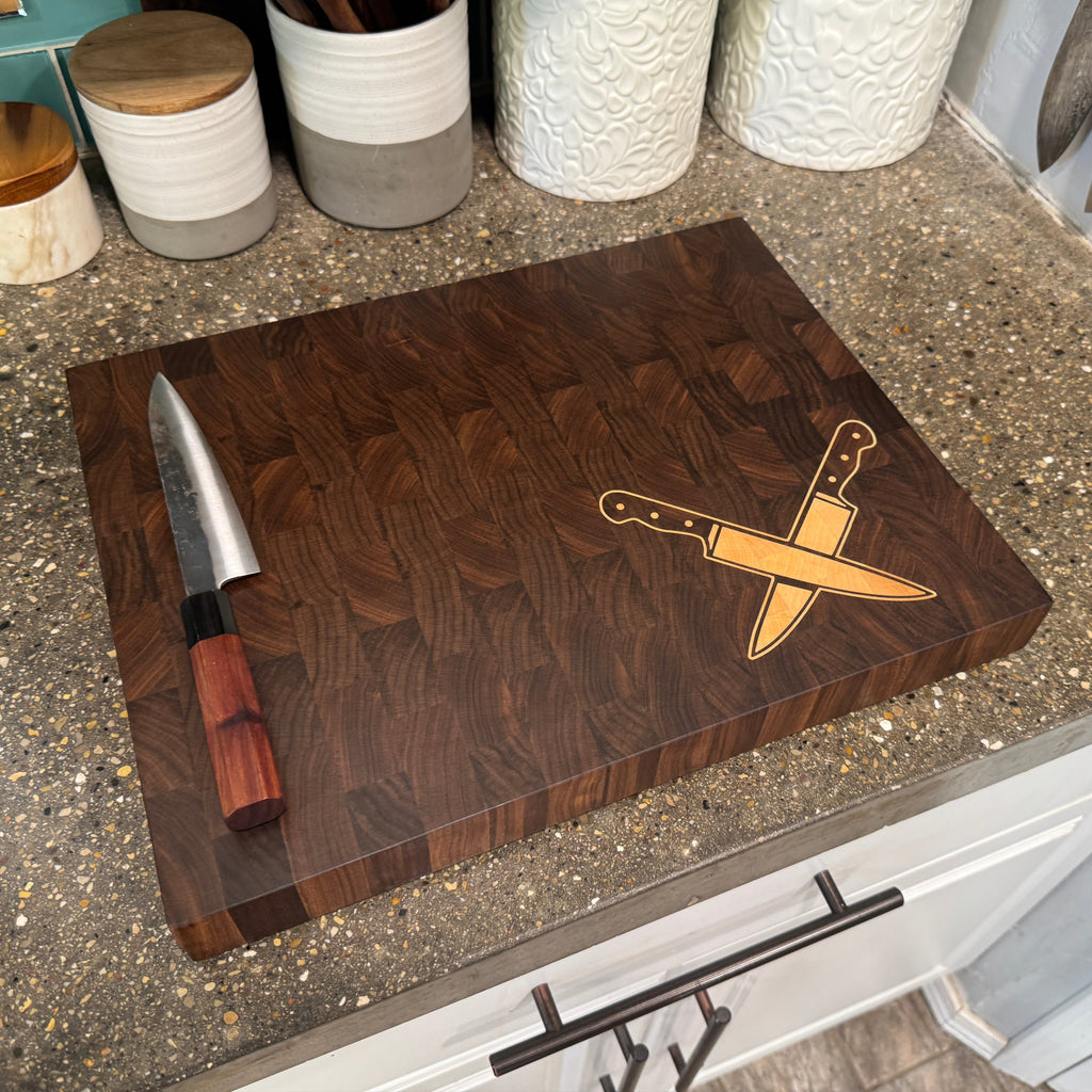 Wooden cutting board with knife design on a kitchen counter