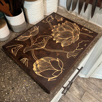 Decorative cutting board with floral design on a kitchen counter