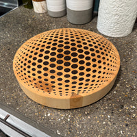 wooden cutting board with illusion design on counter
